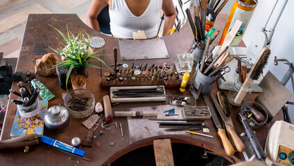 Sticker - Young female jeweler making jewelry in workshop