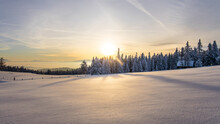 Untouched Winter Landscape With Deep Snow During Sunset On A Mountain Pasture In Austria