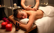 © H_Ko - Girl relaxed lying massage, near candles and oil. Gentle caring hands master. Massage in relaxing atmosphere filled with fragrant aromas. Classic luxury massage for purpose prevention