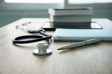 In A Hospital Setting, The Presence Of A Doctor's Physician Book And Stethoscope Carries With It An Air Of Professionalism And Dedication To Patient Care.