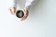 © Morng - top view of female hands and cup of coffee