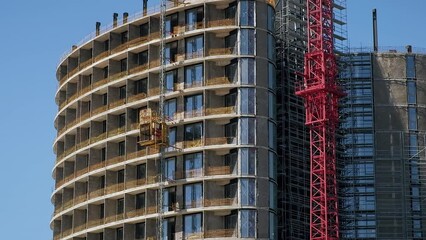 Wall Mural - Construction Site. Freight lift elevator moving. Blue sky. Modern city concept