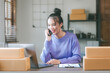 © Witoon - Starting a Small Business Entrepreneur Young freelance asian woman working at home office box smartphone laptop online marketing packaging sme ecommerce concept