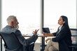© Friends Stock - Two business colleagues talking in meeting room during work on project. Teamwork concept