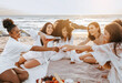 © Prostock-studio - Summer picnic at sunset. Group of happy diverse women pouring champagne in glasses, having bachelorette party
