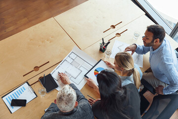 Wall Mural - Top view of professional business managers working with project documents in office 