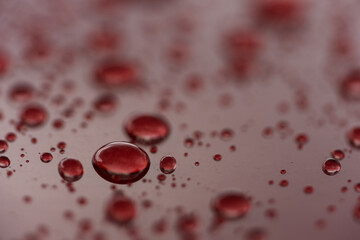 Wall Mural - Rain droplets on red sports car surface with hydrophobic treatment