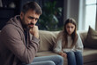 © Lazy_Bear - Relationship between father and child. Difficult conversation with teenager. Serious dad and sad daughter sitting on sofa and talking. Family problems