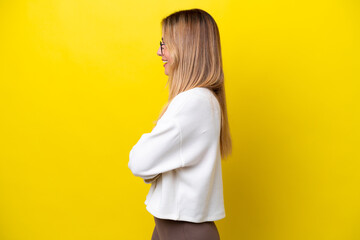 Wall Mural - Young Uruguayan woman isolated on yellow background in lateral position