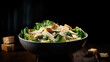 Classic Caesar salad with chicken, iceberg salad, croutons, parmesan cheese and caesar dressing. Black table background, top view.