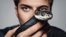 A Man Holds A Snake In Front Of His Face And Fights Fear