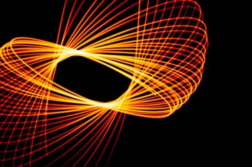 Wall Mural - random spin shapes made with bright yellow light painting on black background