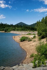 Wall Mural - Scenic view of a tranquil lake surrounded by greenery in Fuzina, Croatia