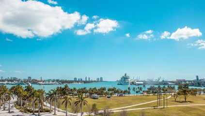 Sticker - Scenic ocean featuring several tall palm trees on the shoreline and a few boats in the distance