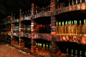 Wall Mural - Many bottles of different alcohol drinks on shelves in cellar