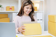 © mangpor2004 - Young asian woman , small business owner packing product box at home office