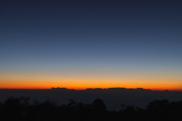 Heaven at early morning with copy space. Sunset, sunrise backdrop.Predawn clear sky with orange horizon and blue atmosphere. Smooth orange blue gradient of dawn sky.