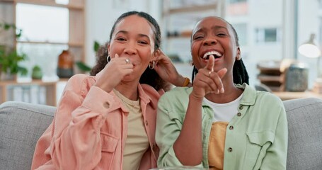 Wall Mural - Girl friends, laughing and watching tv with popcorn, pointing or face for choice, movie or click on sofa. Women, eating and relax on lounge couch in portrait, comedy and streaming comic show in house