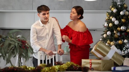 Wall Mural - Young couple quarreling - husband expresses displeasure to wife during new year celebration