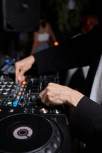 Hands Of Male Dj Playing Music On Modern Midi Controller Turntable. Digital Device For Mixing Music On Events And In Studio.