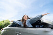 Young beautiful asian women getting new car. She relaxing out of window in a car - Freedom car travel concept