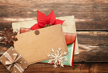 Canvas Print - Christmas background with retro card, vintage envelope, poinsettia, gift and wooden snowflakes on old wooden boards. Nostalgic scrapbooking backdrop. Copy space for text