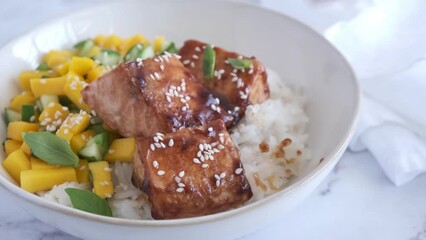 Canvas Print - Teriyaki salmon with rice and mango in a white bowl. Asian cuisine concept.