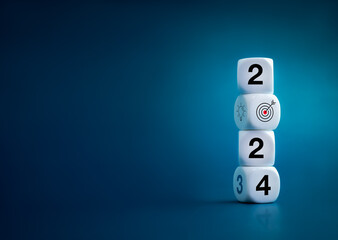 Poster - 2024 Happy New year background banner. Numbers and target dart icon on white blocks stacked on dark blue background with copy space. Welcome, Merry Christmas, and Happy New Year in 2024.
