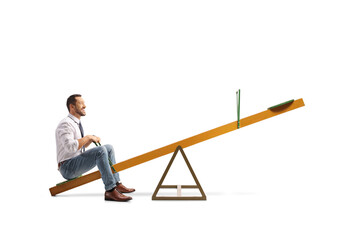 Wall Mural - Businessman sitting on a seesaw alone