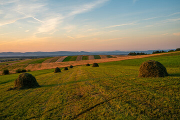 Wall Mural - Haystacks on a mountain meadow