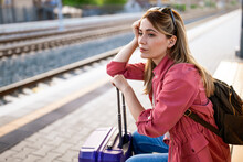 Adult Woman Is Sitting At Railway Station And Waiting For Arrival Of Train.