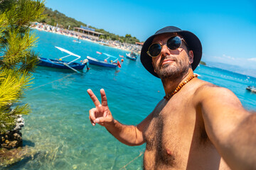 Wall Mural - Selfie of a tourists on the beaches of Ksamil in the Albanian riviera enjoying the summer holidays