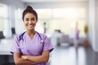 young hispanic nurse, medical blurry background