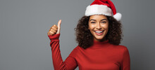 Hispanic Christmas Girl In Santa Hat Doing Thump Up