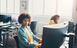 © Flamingo Images - Young businesswoman and a colleague working on computers in an office