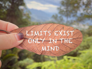 Wall Mural - Motivational and inspirational wording. Limit Exist Only In The Mind written on dead leaf. With blurred styled background.