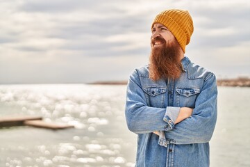 Poster - Young redhead man smiling confident standing with arms crossed gesture at seaside