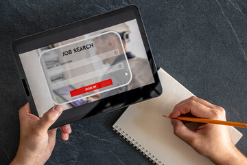 Wall Mural - top view of digital tablet with search job on screen in male hands.