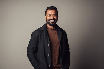 Wall Mural - Medium shot portrait of an Indian man in his 30s in a minimalist background