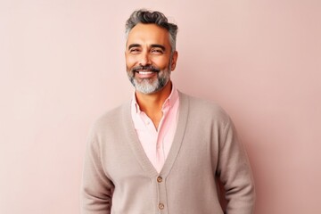 Medium shot portrait of an Indian man in his 40s in a colorful background