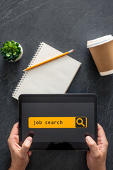 Wall Mural - top view of digital tablet with search job on screen in male hands.