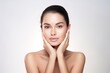 © radekcho - Skin care. Woman with beauty face touching healthy facial skin portrait. Beautiful smiling girl model with natural makeup touching glowing hydrated skin on light background closeup.