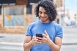 © Krakenimages.com - Young latin man smiling confident using smartphone at street