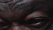 Macro Extreme Close-up Of An Elderly Black Man's Blue Eyes In Deep Mental Reflection, Old Age Wrinkles In Contemplation