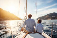 Back View Of Father And Son Family Sailing On A Luxury Yacht
