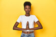 © Asier - African woman, white tee, short hair, yellow studio, praying, showing devotion, religious person looking for divine inspiration.