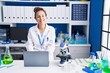 © Krakenimages.com - Young woman scientist using laptop working at laboratory