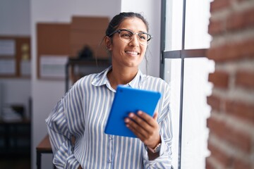 Sticker - Young beautiful hispanic woman business worker smiling confident using touchpad at office