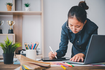 Fototapete - Graphic designer architects who work with laptops and color comparison tables for design work..
