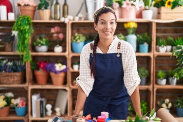 Canvas Print - Young beautiful hispanic woman florist smiling confident standing at florist